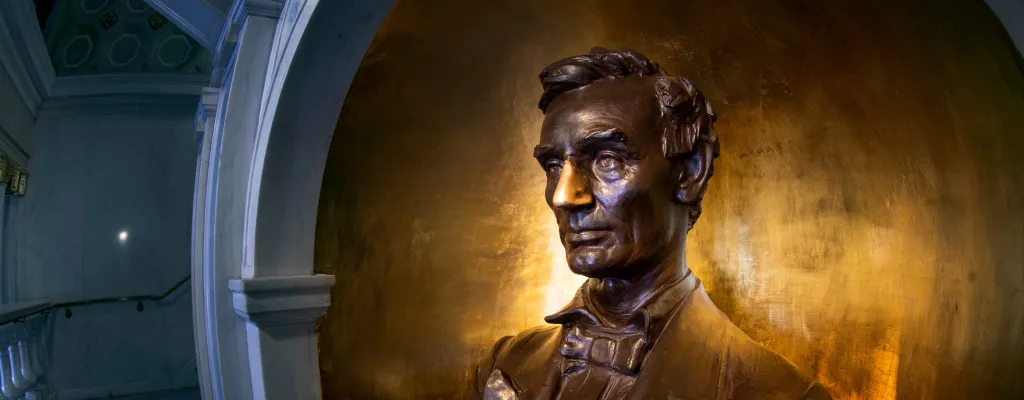 A bust of Abraham Lincoln watches as students travel to classes at Lincoln Hall at the University of Illinois at Urbana–Champaign. Lincoln’s nose is shiny bright from the thousands of students who have reached out to rub his nose, seeking a little good luck from ‘Honest Abe.’