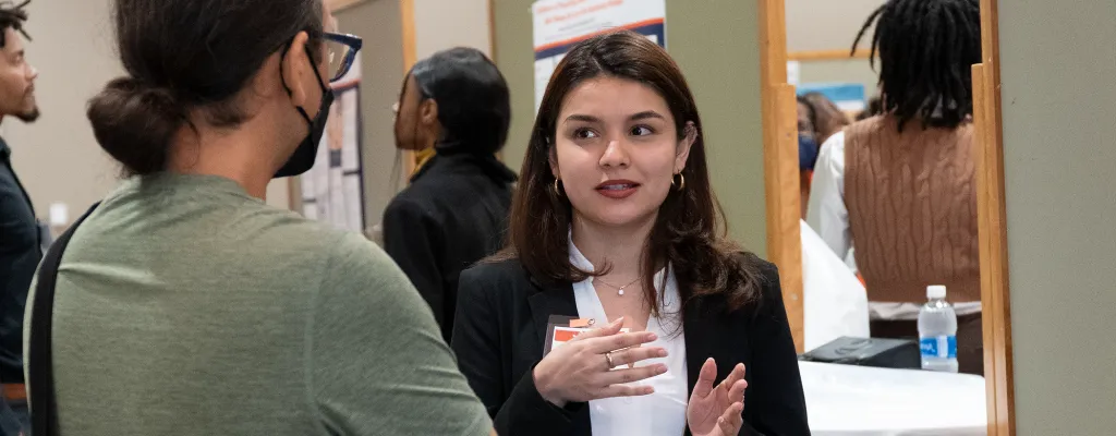 student presenting her work at Illinois Student Research Symposium