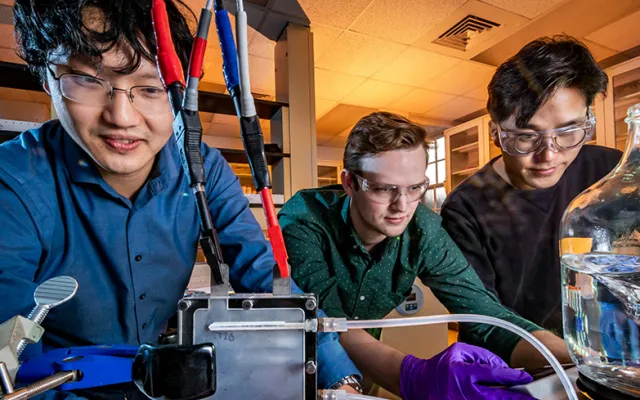 Professor Xiao Su, left, graduate student Stephen Cotty, center, and postdoctoral researcher Kwiyong Kim have developed an energy-efficient device that selectively absorbs a highly toxic form of arsenic in water and converts it into a far less toxic form. 