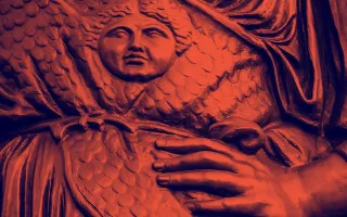 Detail of Alma Mater sculpture showing a hand on hip. 