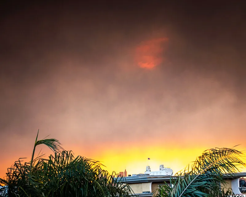 Smoke from the wildfires light up the sunrise over downtown Los Angeles, California, on January 8, 2025.