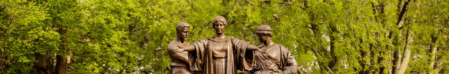 Alma Mater with orange flowers in the foreground.